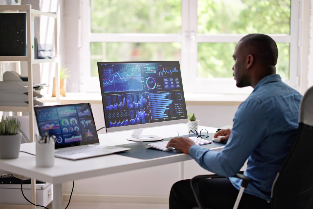 A desktop monitor displaying an SEO analytics dashboard with charts and keyword insights, emphasizing backlinks and keyword rankings.