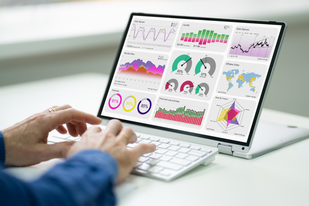 A laptop displaying an analytics dashboard with SEO competitor insights, featuring keyword rankings, backlinks, and traffic analysis in a modern workspace.