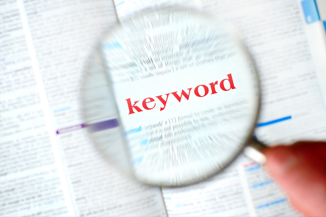 Keyword research process with a magnifying glass, search bar, and digital analytics dashboard.