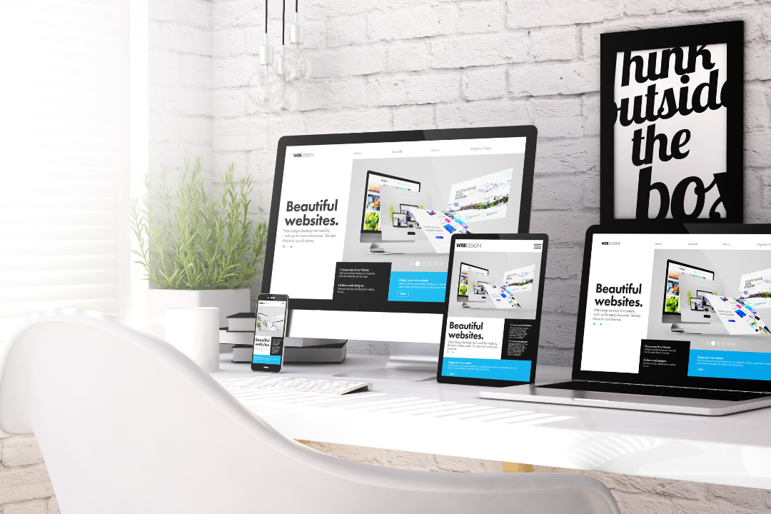 A modern digital workspace with a laptop and smartphone displaying a responsive website, highlighting mobile-first indexing and SEO-related graphics in the background.