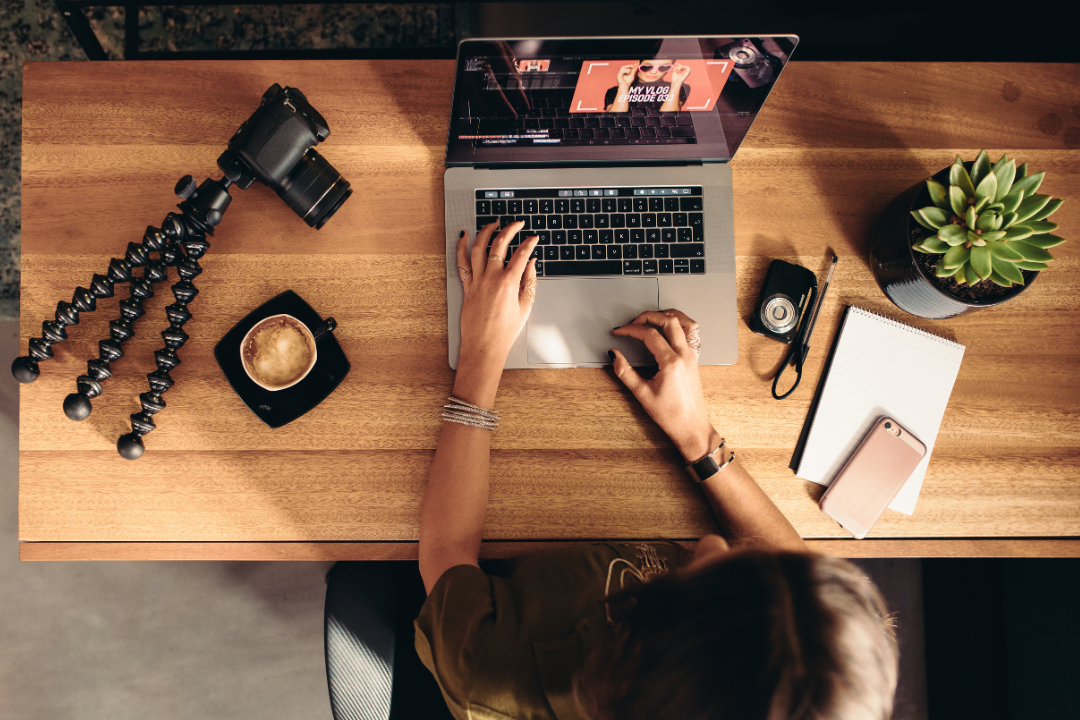 Digital marketer networking with influencers through email outreach in a modern office