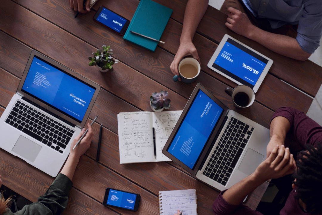 Business team collaborating with digital marketing workflows visualized in the background.