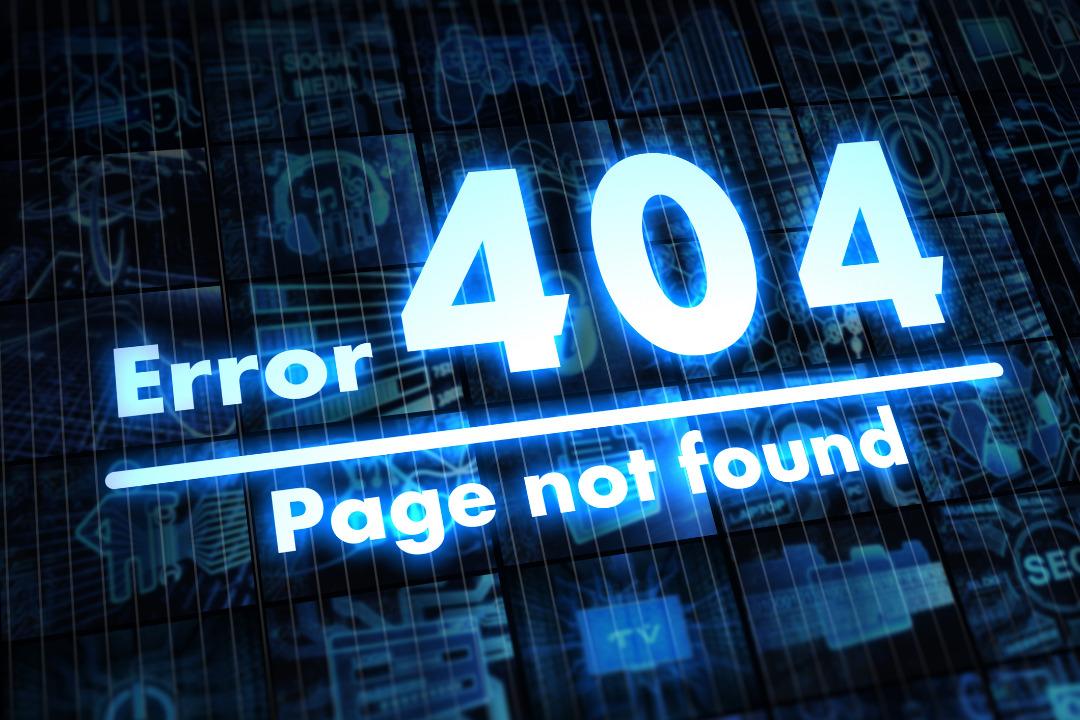 A website administrator sits at a modern desk fixing broken links on a large screen showing 404 errors and redirect settings.